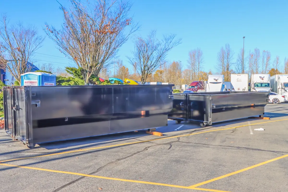 Professional dumpster rental service with roll-off container on residential driveway in Kennedy